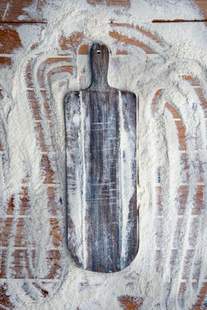 White flour on old rustic wooden table, top view. Copy space for your text. Kneading the Dough.