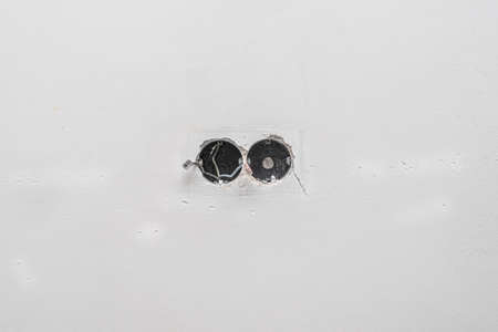 Electrical wire and opened junction box on the old white wall. Electrical works on construction site.の写真素材