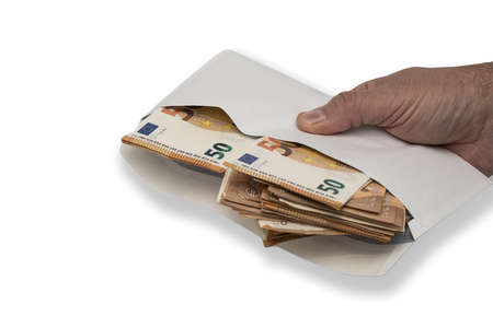 Close-up. An envelope with euro bills in a mans hand. Isolated on white background. Banknotes of the...