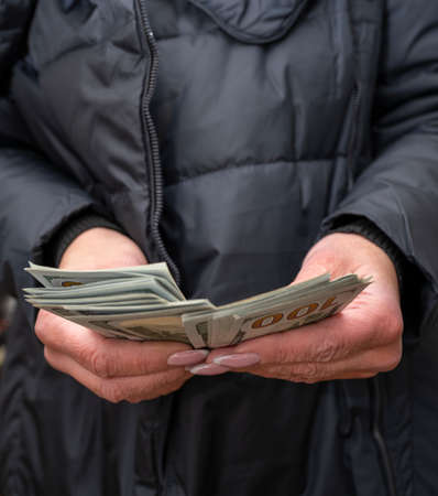 Bunch of 100 dollar in female hands. Business. Dollars and prosperity. Selective focus