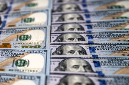 Background with banknotes of american 100 dollars bills. Cash money banknotes. Selective focus