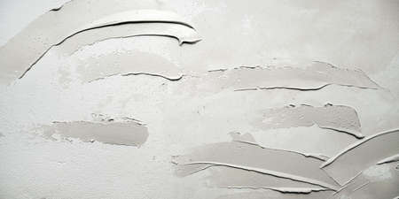 Dirty, shabby white wall with putty stainsの写真素材