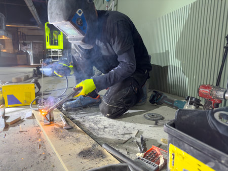 Welding with argon or electrode, using a welding machine. Sparks and flashes fly.