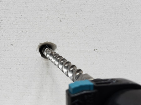 Work of a jackhammer. Drilling hole in concrete wall.の写真素材