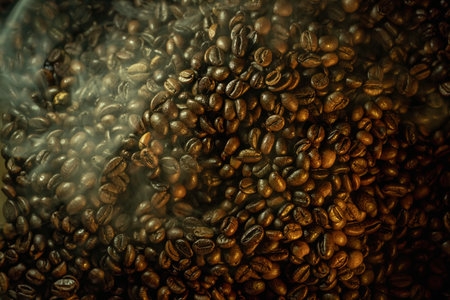 Close-up of roasted coffee beans with soft steam and haze, dramatic warm lighting, rich texture...