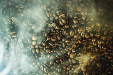 Close-up of roasted coffee beans with soft steam and haze, dramatic warm lighting, rich texture...