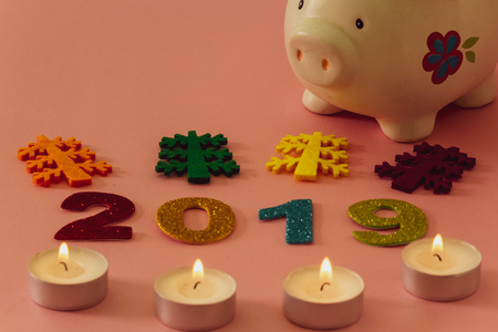 Happy New Year 2019 on a pink background with a piggy bankの写真素材