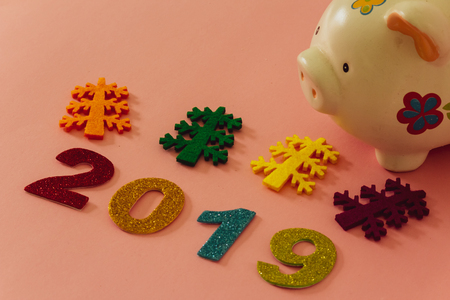 Happy New Year 2019 on a pink background with a piggy bankの写真素材