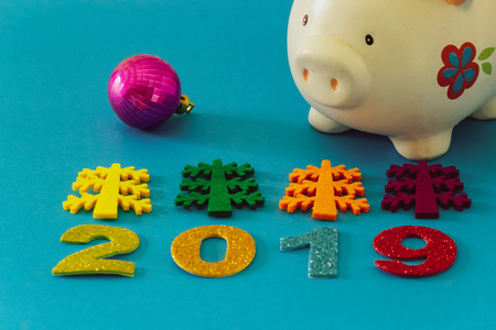 Happy New Year 2019 on a blue background with a piggy bankの写真素材