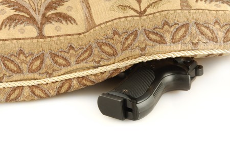 The weapon under east pillow isolated on white background (closeup)の写真素材