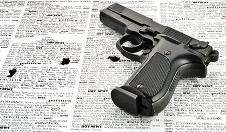 vintage handgun isolated on newspaper (closeup)の写真素材