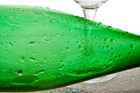 bottle from green glass and wineglass  on whiteの写真素材