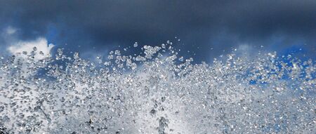 sparks of water on a background grey skyの写真素材