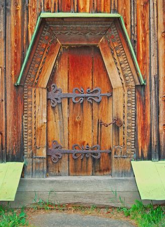 age-old door from a dark tree of the abandoned buildingの写真素材
