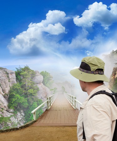 tramp looking into wooden bridge, view of the mountain fogの写真素材