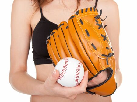 young girl , wearing a baseball mitt and catching a soft ball.の写真素材
