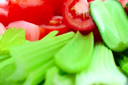 tomatoes, cucumbers, lettuce and condiments in the backgroundの写真素材