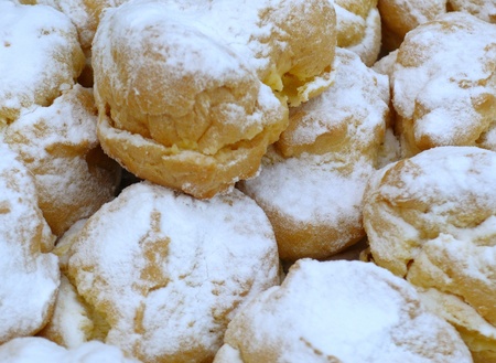 eclairs, covered with vanilla icing sugar as a backgroundの写真素材