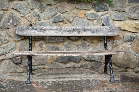 park bench against the stone wallの写真素材