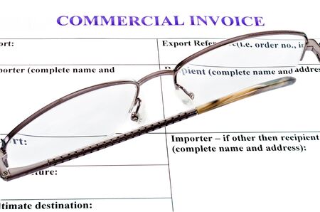 spectacles lie on the form of commercial invoiceの写真素材