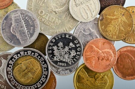 small coins of different countries and years as a background