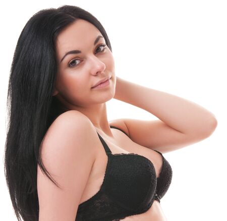 Portrait of a brunette in black lingerie on white backgroundの写真素材