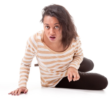 aggressive dark skinned girl in a striped T-shirt and leggings on a white backgroundの写真素材
