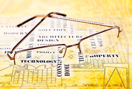 glasses lie on the ancient art engineering backgroundの写真素材