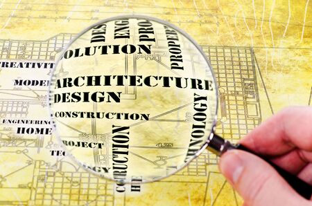 human hand with a magnifying glass on the art architectural background