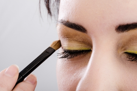 close up of woman applying makeupの写真素材