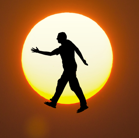 weightlessness on  amazing sunsetの写真素材