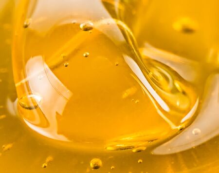 Macro abstract of golden honeyの写真素材