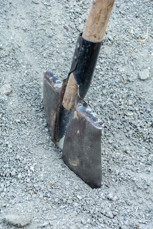 rough bayonet shovel stuck in a pile of gravelの写真素材