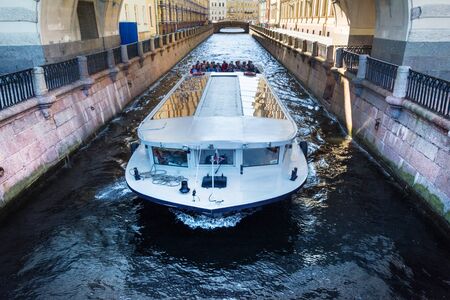 ST. PETERSBURG, RUSSIA - JULY 10, 2016: walking boat moves through a narrow channel near the Hermitage, St. Petersburg, Russia.のeditorial素材