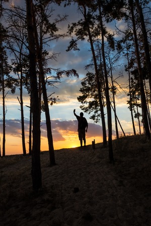 Silhouette of tourist and a beautiful landscape as a backdropの写真素材