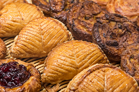 Buns of puff pastry on the shelves of French bakery