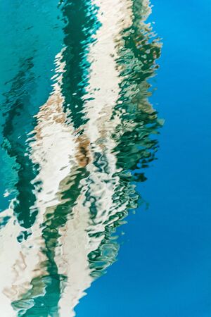 water texture background close up. Bright colorful water reflection.