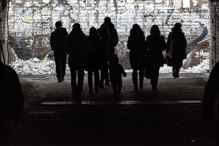 KYIV, UKRAINE - NOVEMBER 18, 2016: Silhouettes of passers-by in the underpass of the poor district of Kyiv, capital of Ukraine.のeditorial素材