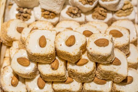 Eastern sweets in a wide range, baklava, Turkish delight with almond, cashew and pistachio nuts on platesの写真素材