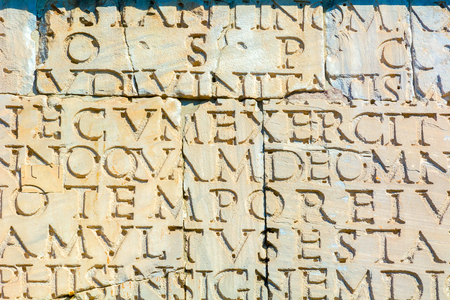 Rome, Italy - Oct 03, 2018: Detail of the triumphal arch of Constantine. The inscription on the south side. Bronze letters are lost, only depressions and mounting holes remain.のeditorial素材