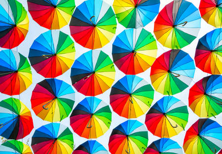Bright colored umbrellas as a joyful backgroundの写真素材