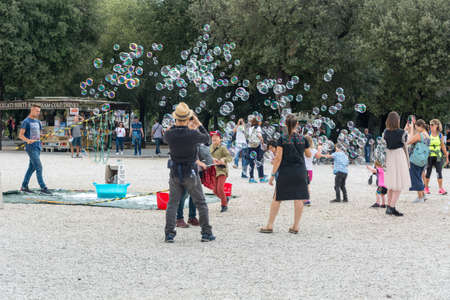 Rome, Italy - Oct 04, 2018: People rejoice in soap bubbles at Terrazza del Pincio in Rome