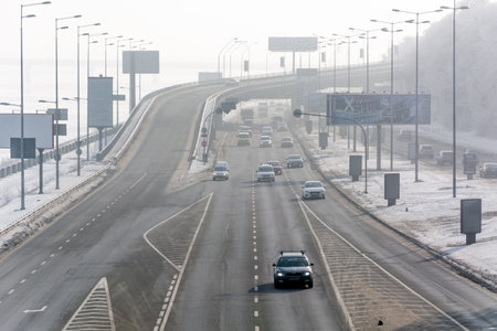 KIEV, UKRAINE - JANUARY 18, 2017: winter landscape, Busy traffic movement along the embankment of the Dnieperのeditorial素材