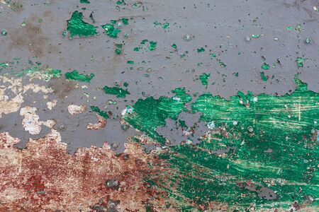 red rusted on the metal wall. green paint. background and Texture for your design.の写真素材