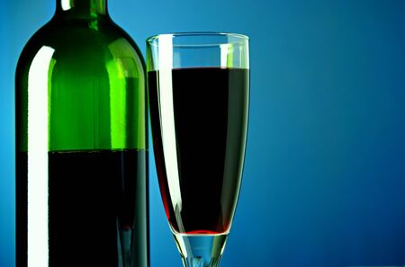 bottle of wine and a glass filled with wineの写真素材