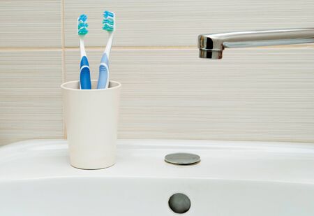 Toothbrushes in a plastic cupの写真素材