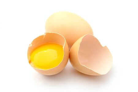 a broken egg on a white background isolatedの写真素材