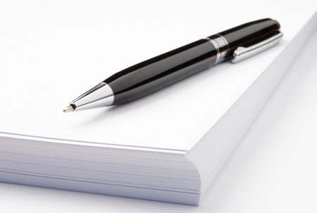 black ballpoint pen and sheets of white paperの写真素材