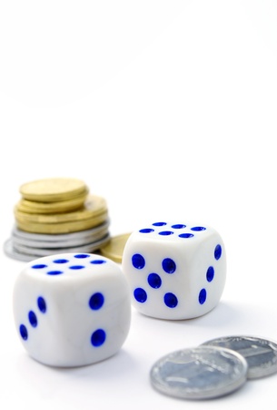 dice and coins on a white backgroundの写真素材