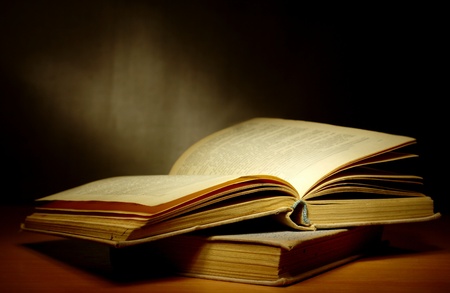 old book on a dark background and light beamの写真素材